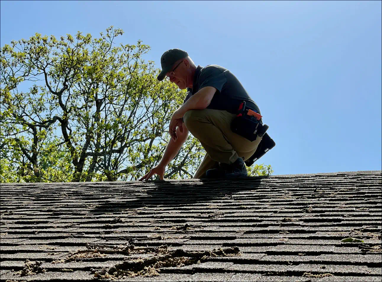 brett smith inspecting the roofing of an oklahoma house